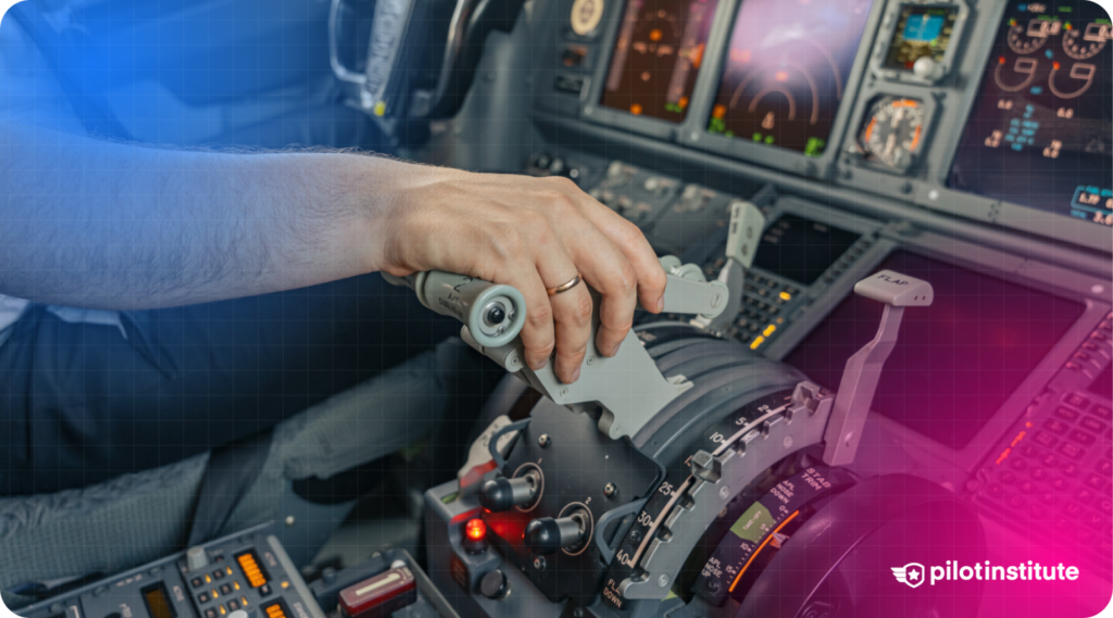 A pilot's hand operating the thrust levers in a commercial aircraft cockpit with illuminated flight instruments.